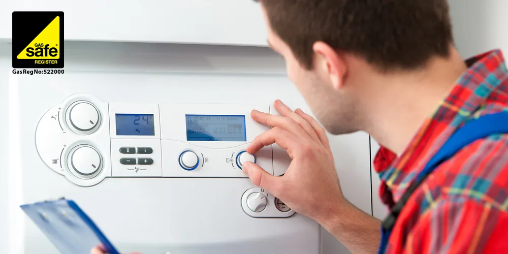 Gas Safe Engineer checking a boiler is ready for winter